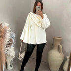 Bouclé poncho met sjaaldetail
