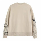 Losvallende wolprint sweater