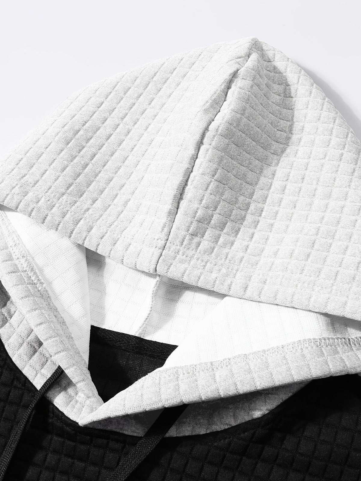 Tweekleurige hoodie met structuur en ribboorden